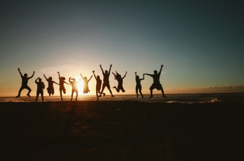 Cornish youth jumping at sunset